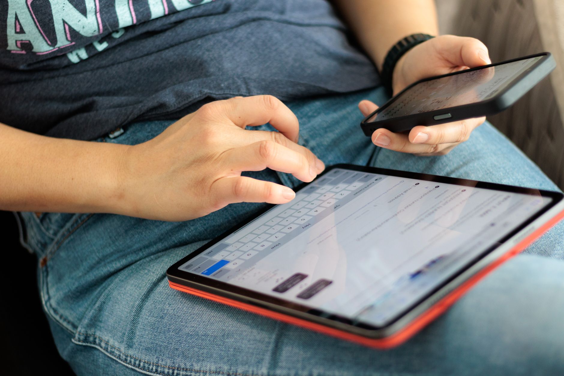 Close-up of hands using tablet to access housing management system