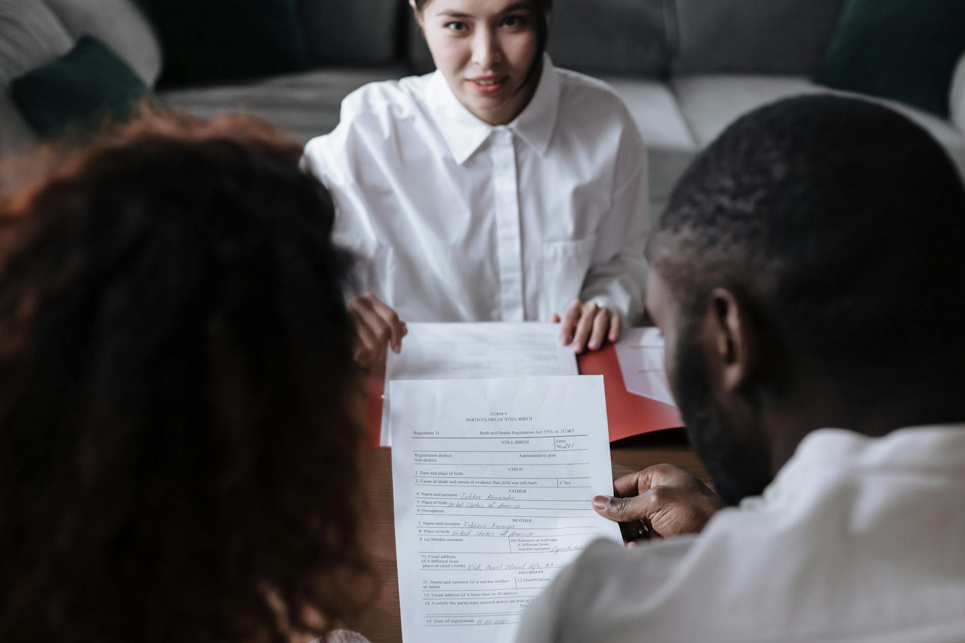  Social worker assisting a refugee family with housing paperwork