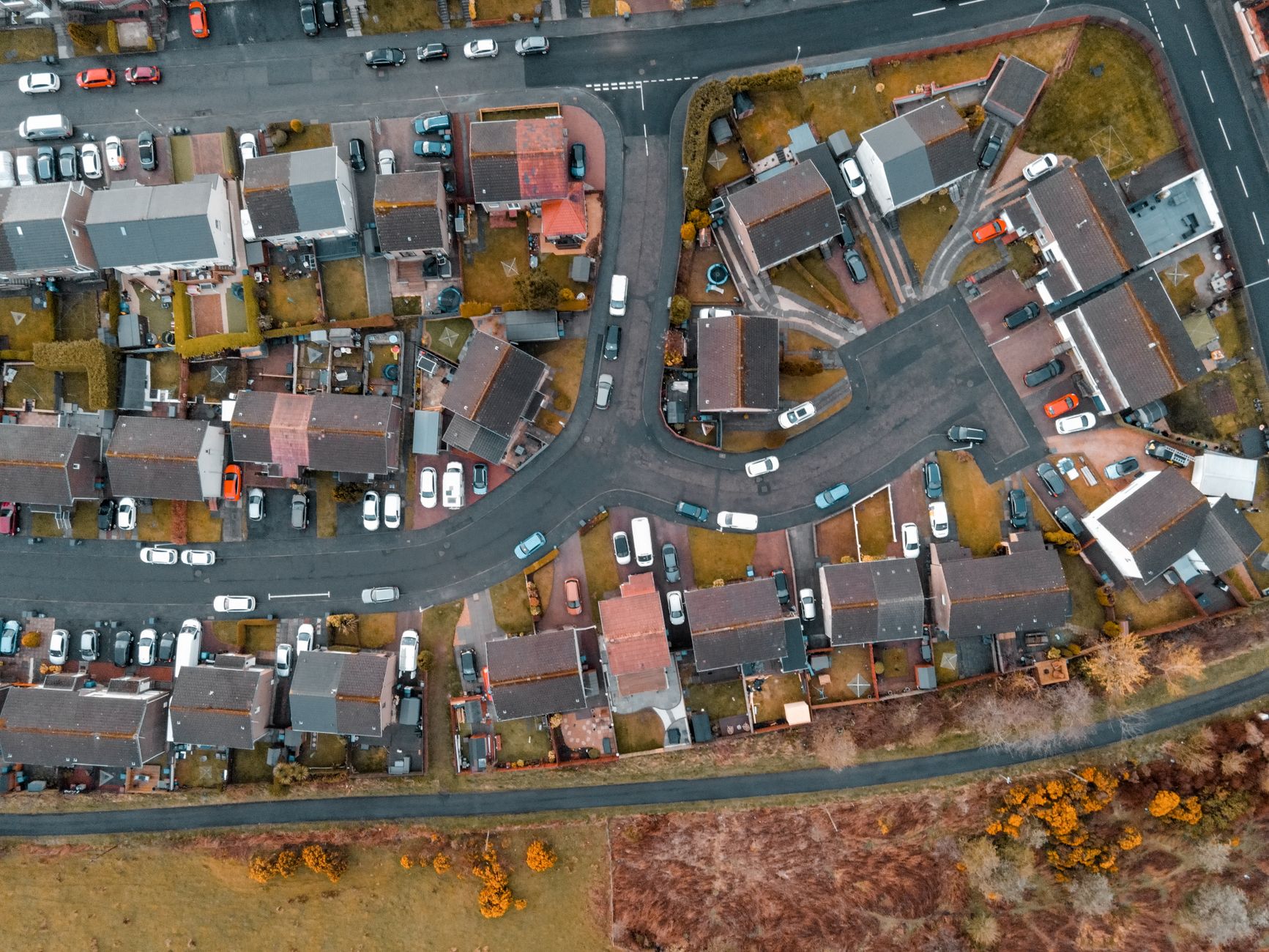 Aerial view of a UK housing estate with mixed property types