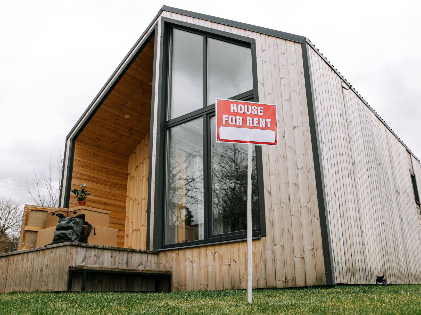 Empty rental property with 'For Sale' sign outside