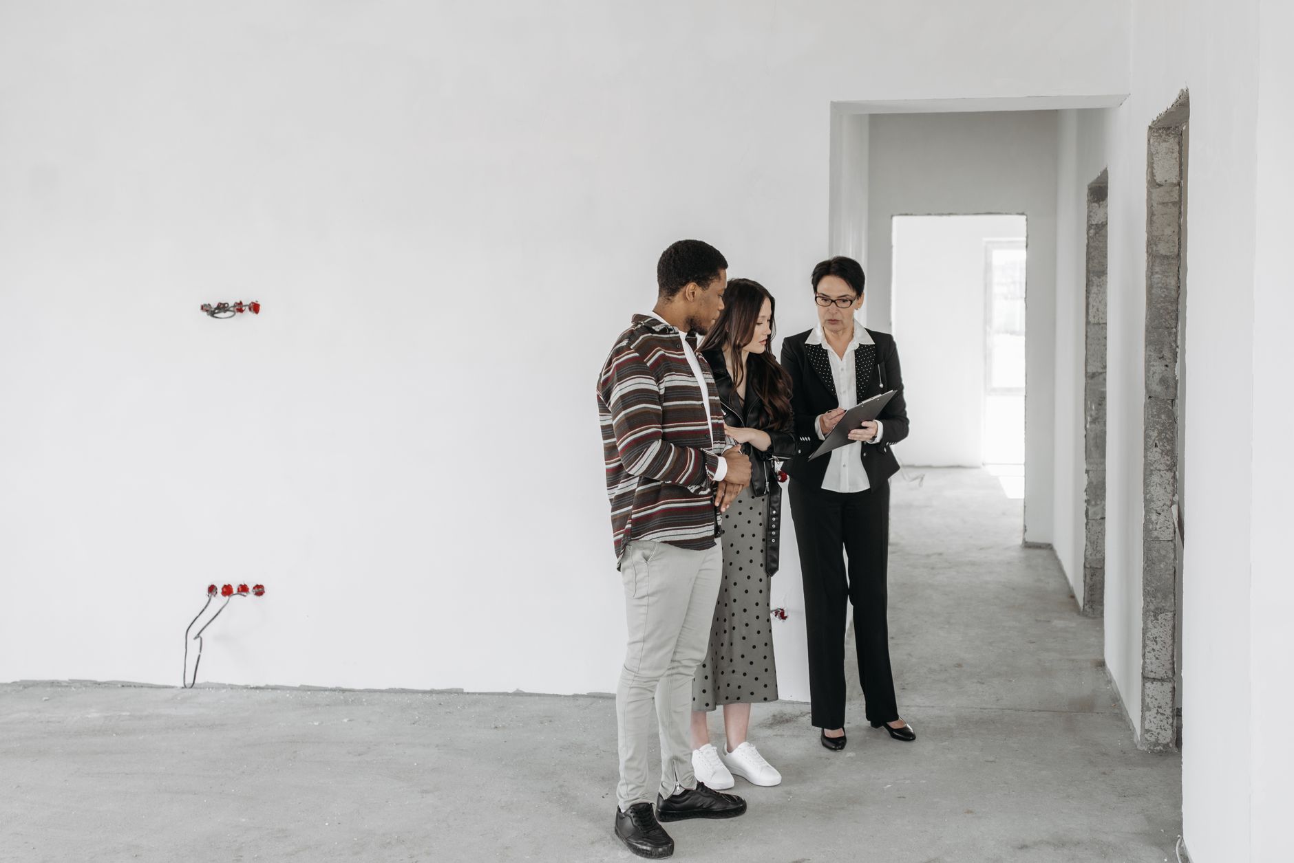 Landlord inspecting a property with a clipboard, looking concerned