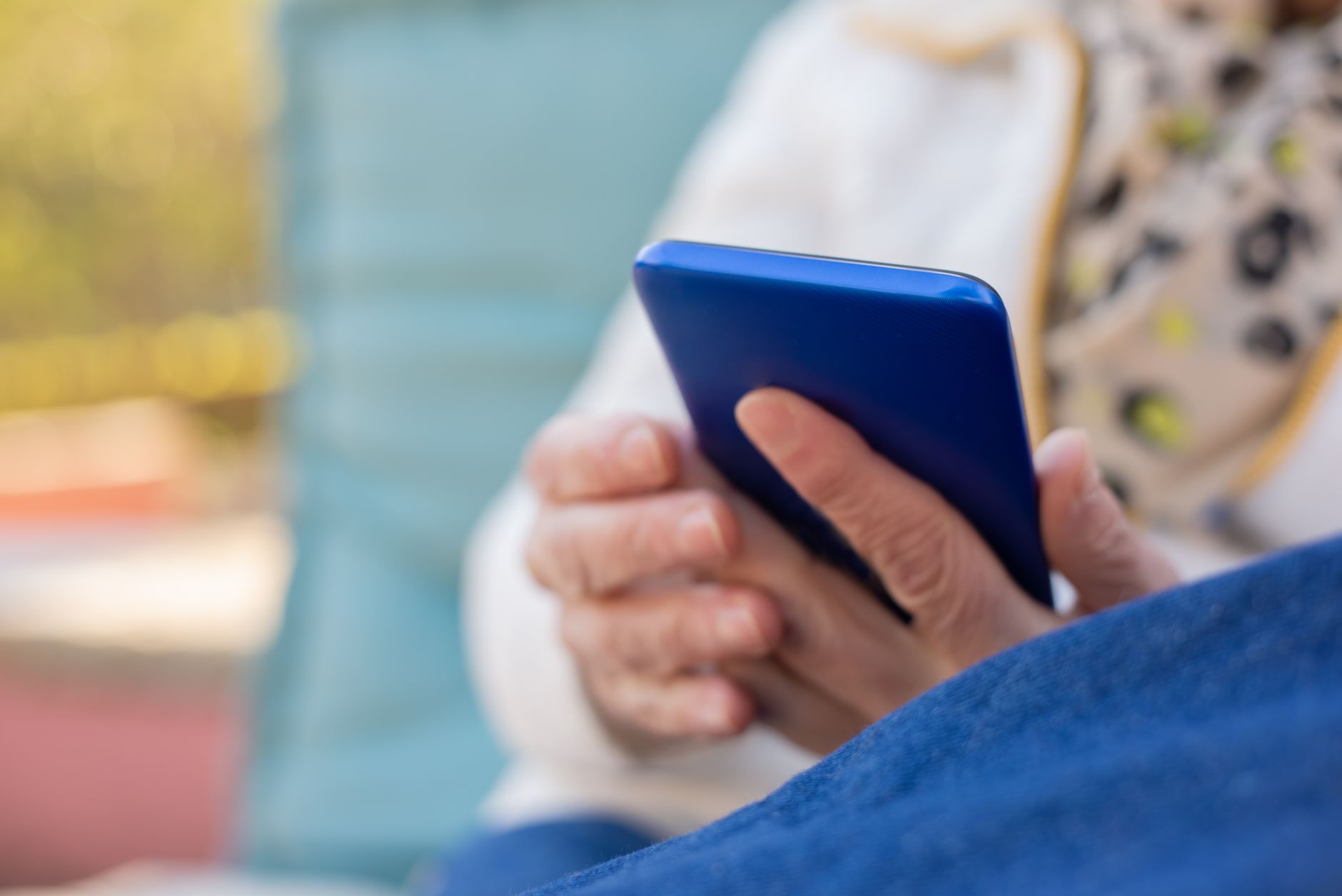 A lonely resident scrolling through their phone in a housing association communal area