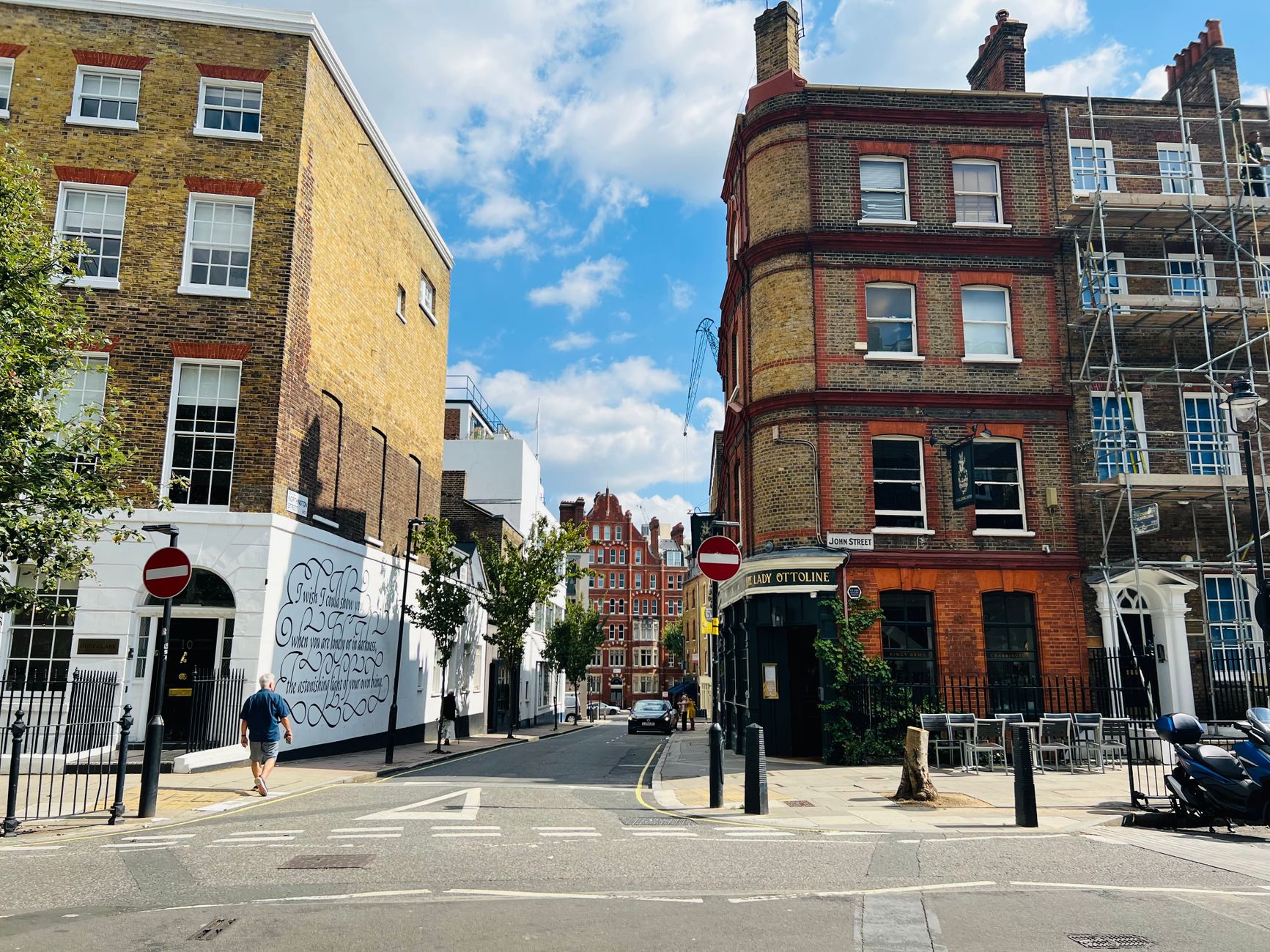 A busy London street with 'To Let' signs in estate agent windows
