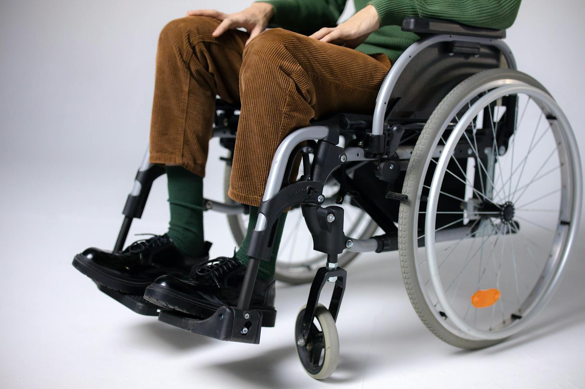 Wheelchair user in adapted bedroom - showing accessibility considerations