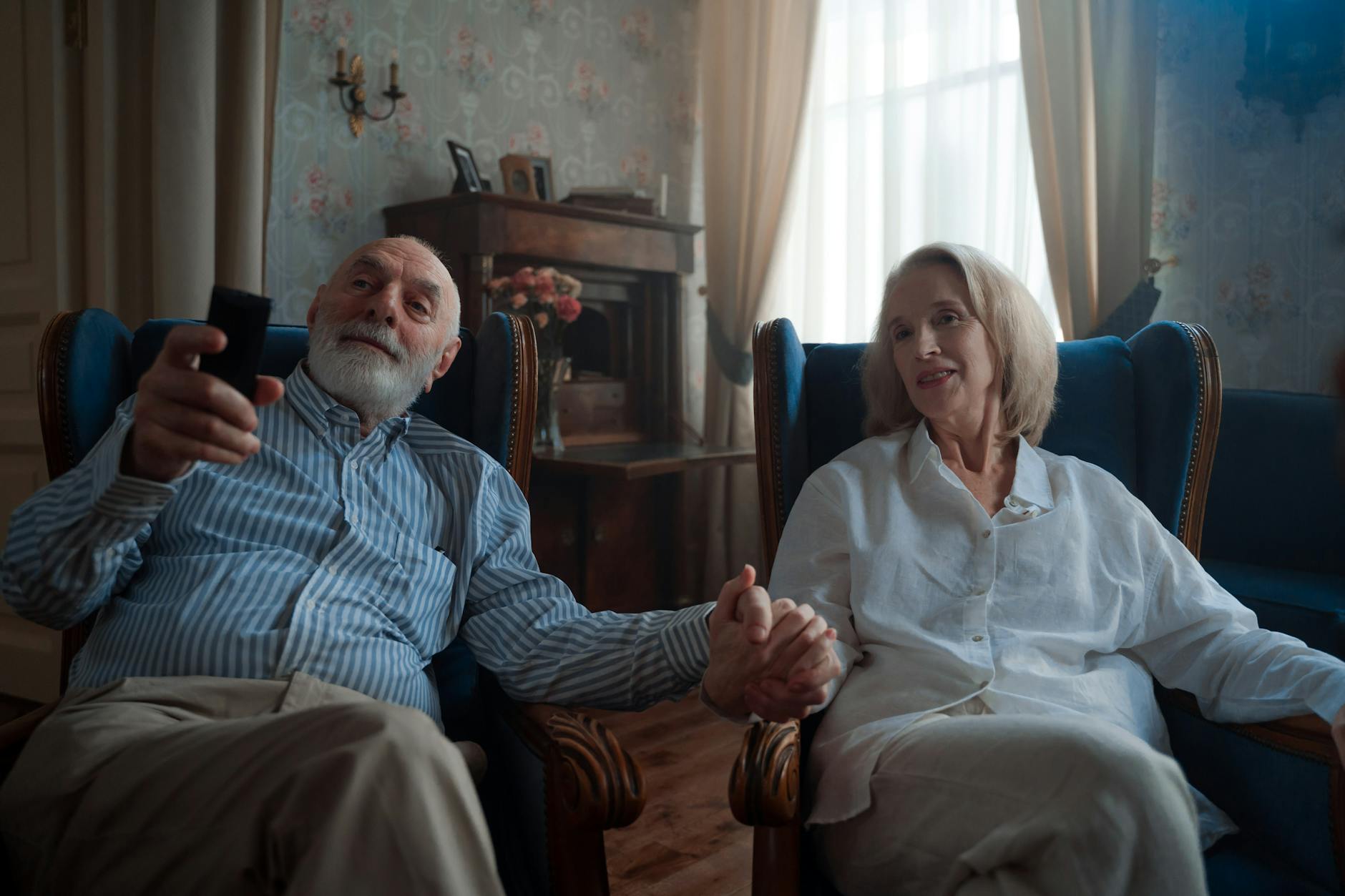 Residents watching TV in a care home lounge - alt text: Elderly residents enjoying television in a communal care home space