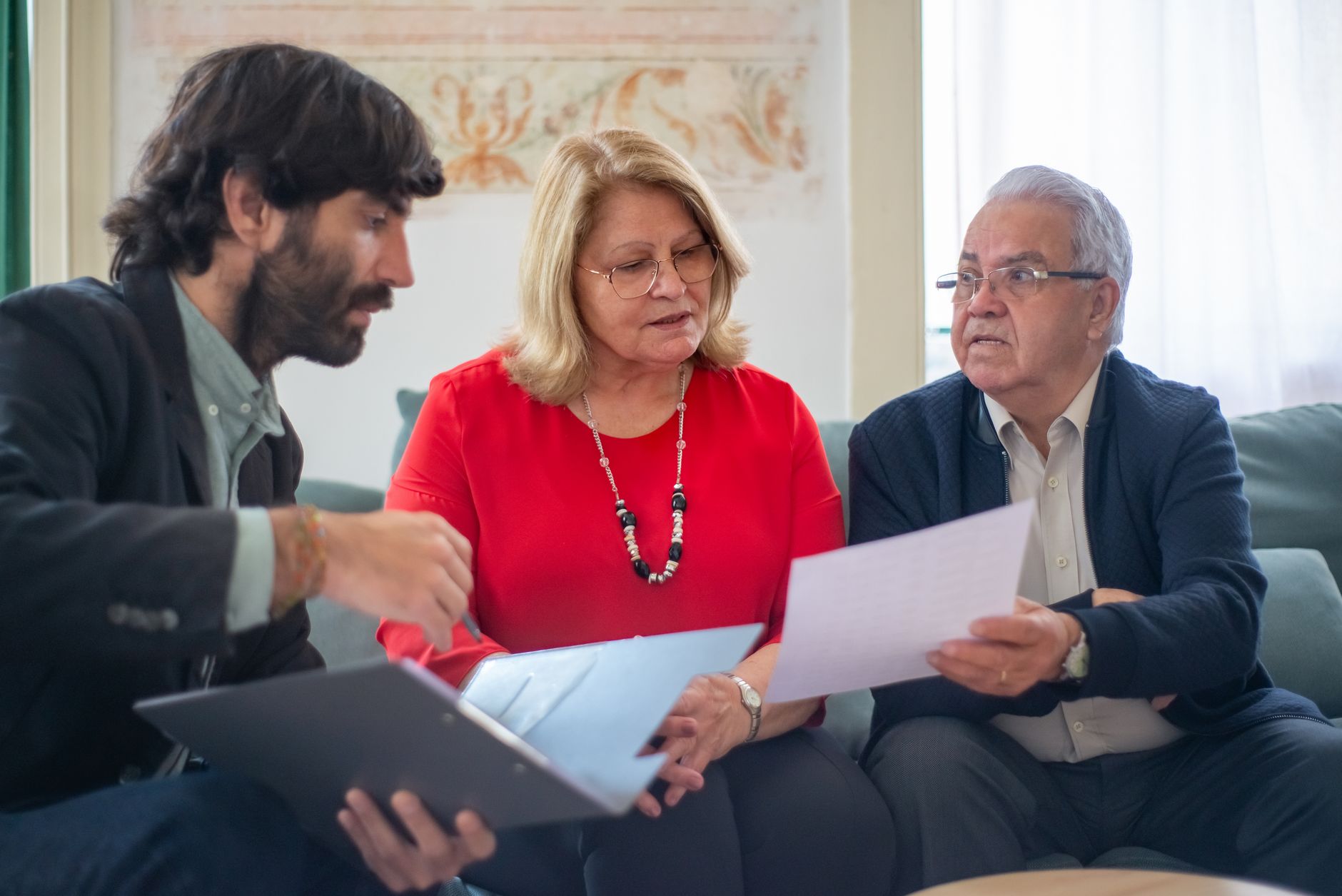 Social worker discussing TV licence with elderly resident - alt text: Housing support worker explaining paperwork to senior resident