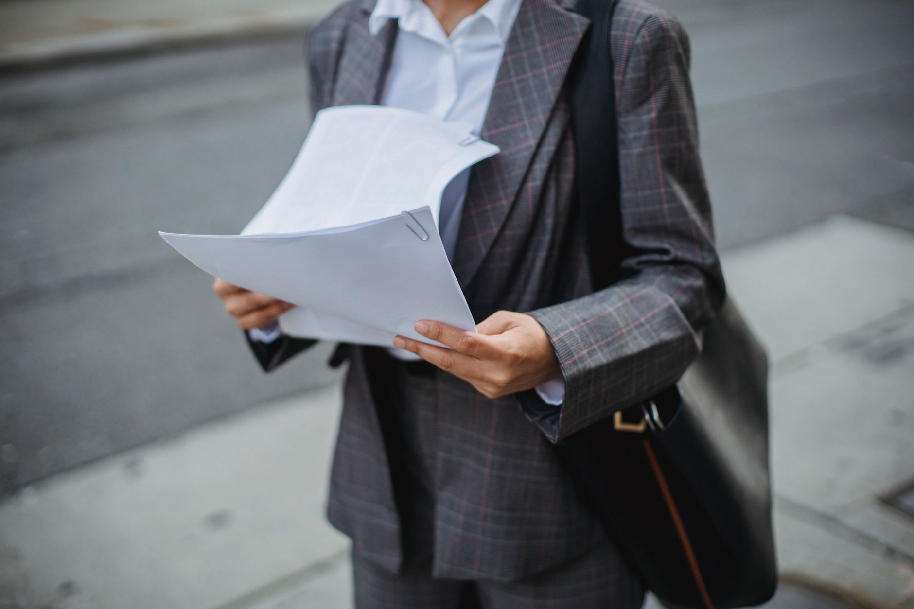 Professional reviewing housing documents - alt text: Housing association worker organising tenant paperwork