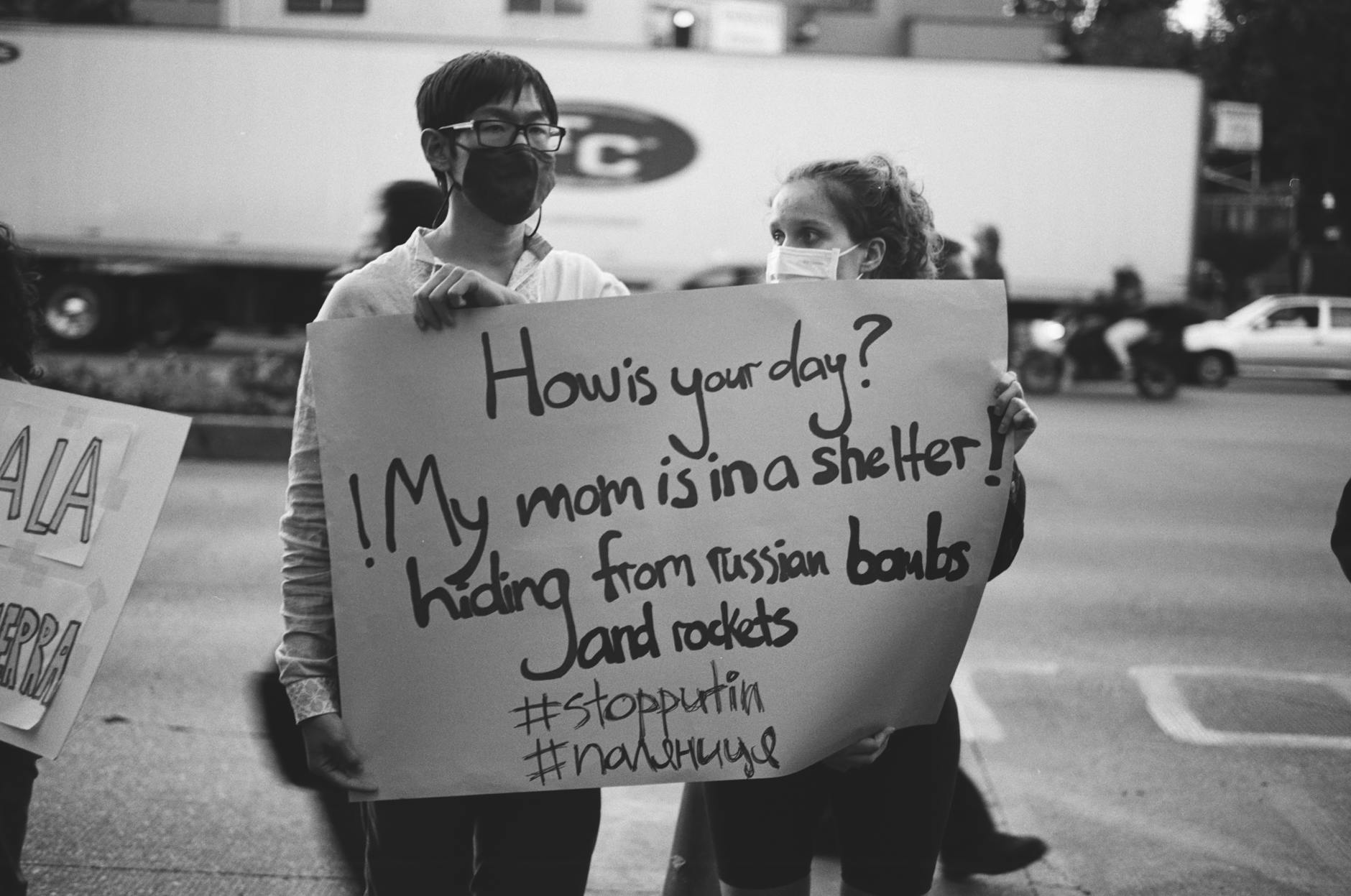 Protesters holding signs about local housing concerns